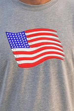 Close-up of the American Flag Swimbait embroidery on a heather grey long-sleeve crewneck