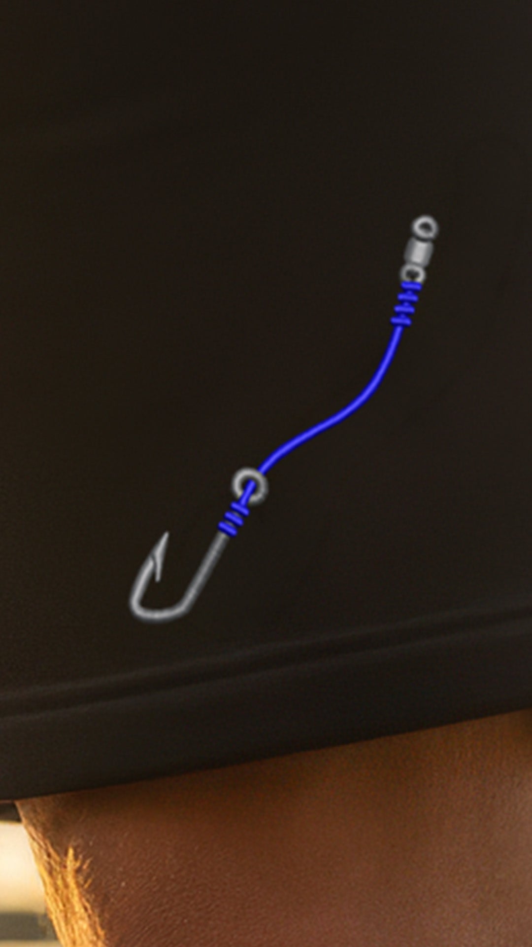 Fishing hook with blue line on a black background