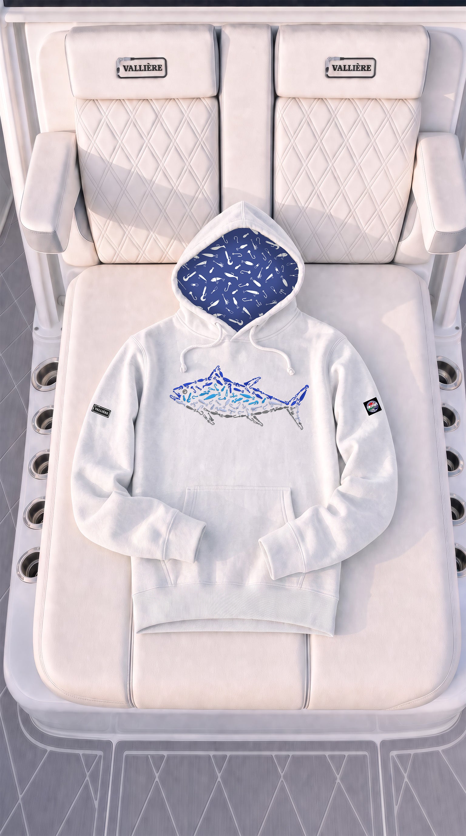 A white pullover hoodie with a blue fish graphic on the chest and a blue patterned hood lining, laid flat on a white boat chair. The brand name 'WALKING' is visible on the headrests of the chair.