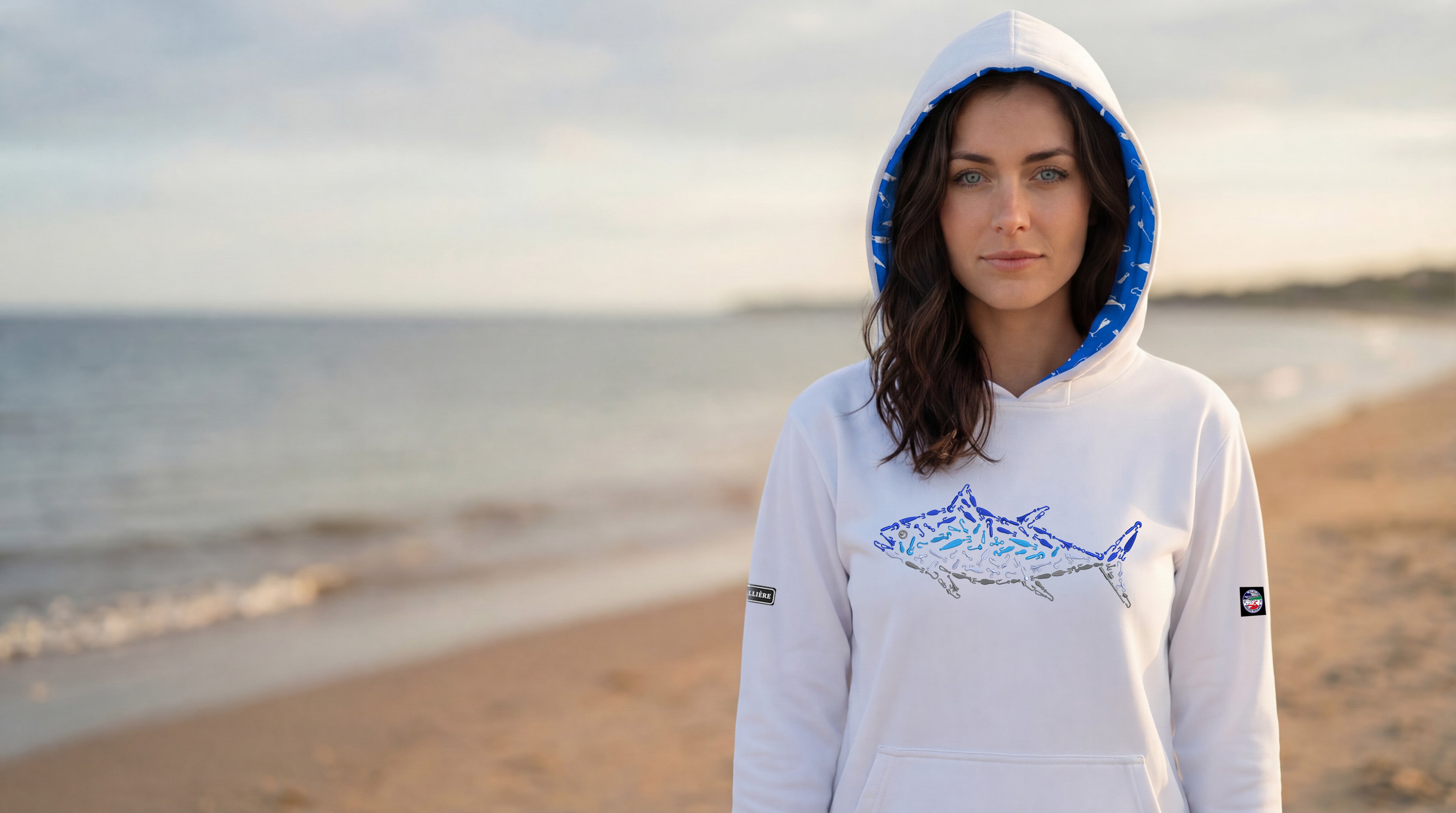 Woman wearing a hoodie with a shark design on a beach