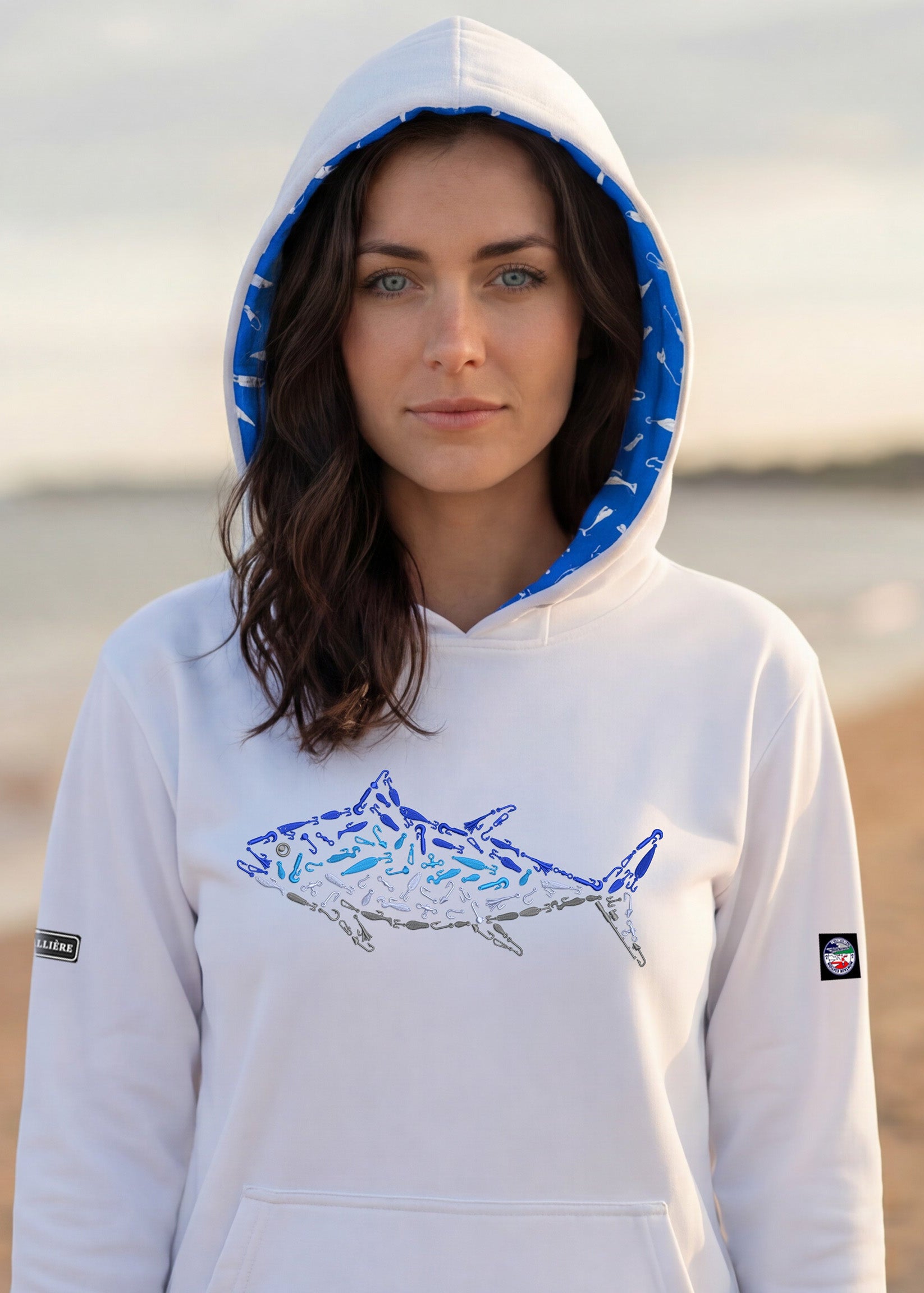 Woman wearing a hoodie with a shark design on a beach